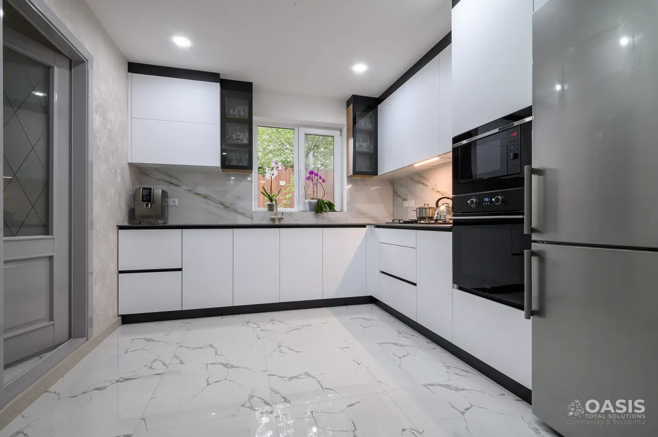 Completed white kitchen with marble-look flooring and backsplash