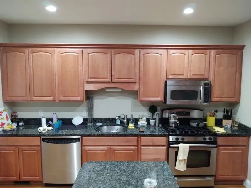Oak kitchen cabinets refinished in a soft cream — before