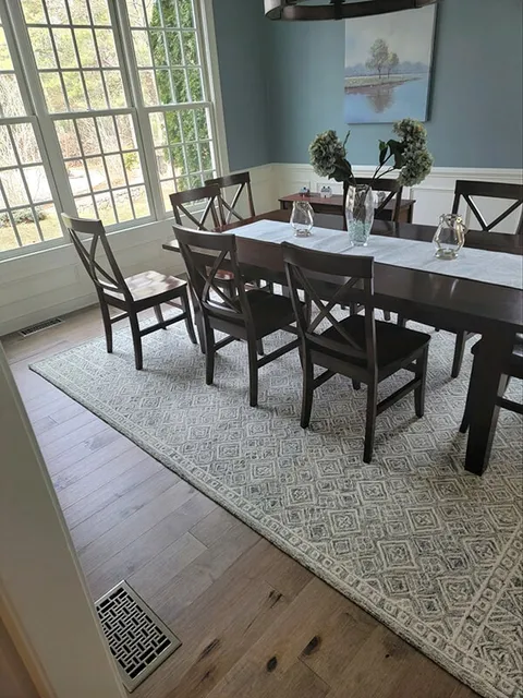 Light hardwood floors in the dining room in Ashland, MA