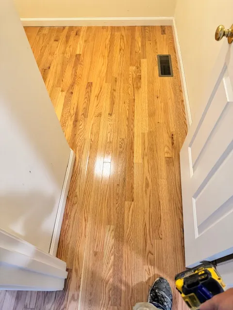 Hallway with newly installed hardwood flooring in Merrimack