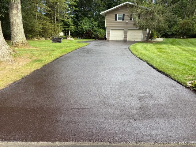 RResidential driveway sealcoating project in Trumbull, CT, leaving behind a clean, smooth finish that complements the property beautifully.