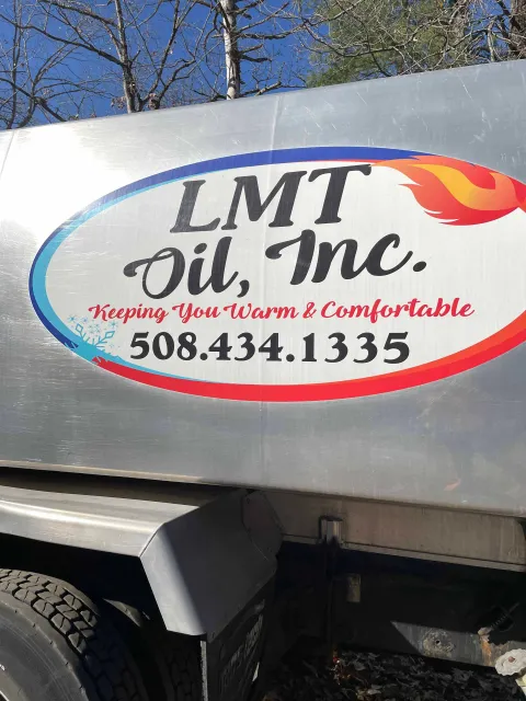 A sign on the side of a truck says lmt oil inc.