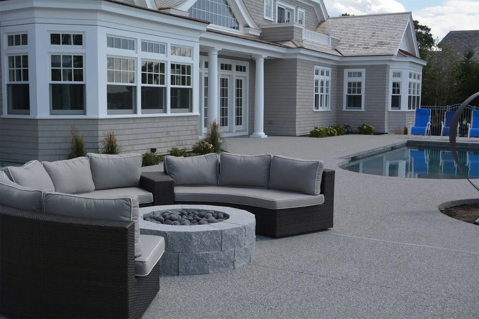A large house with a fire pit in front of it