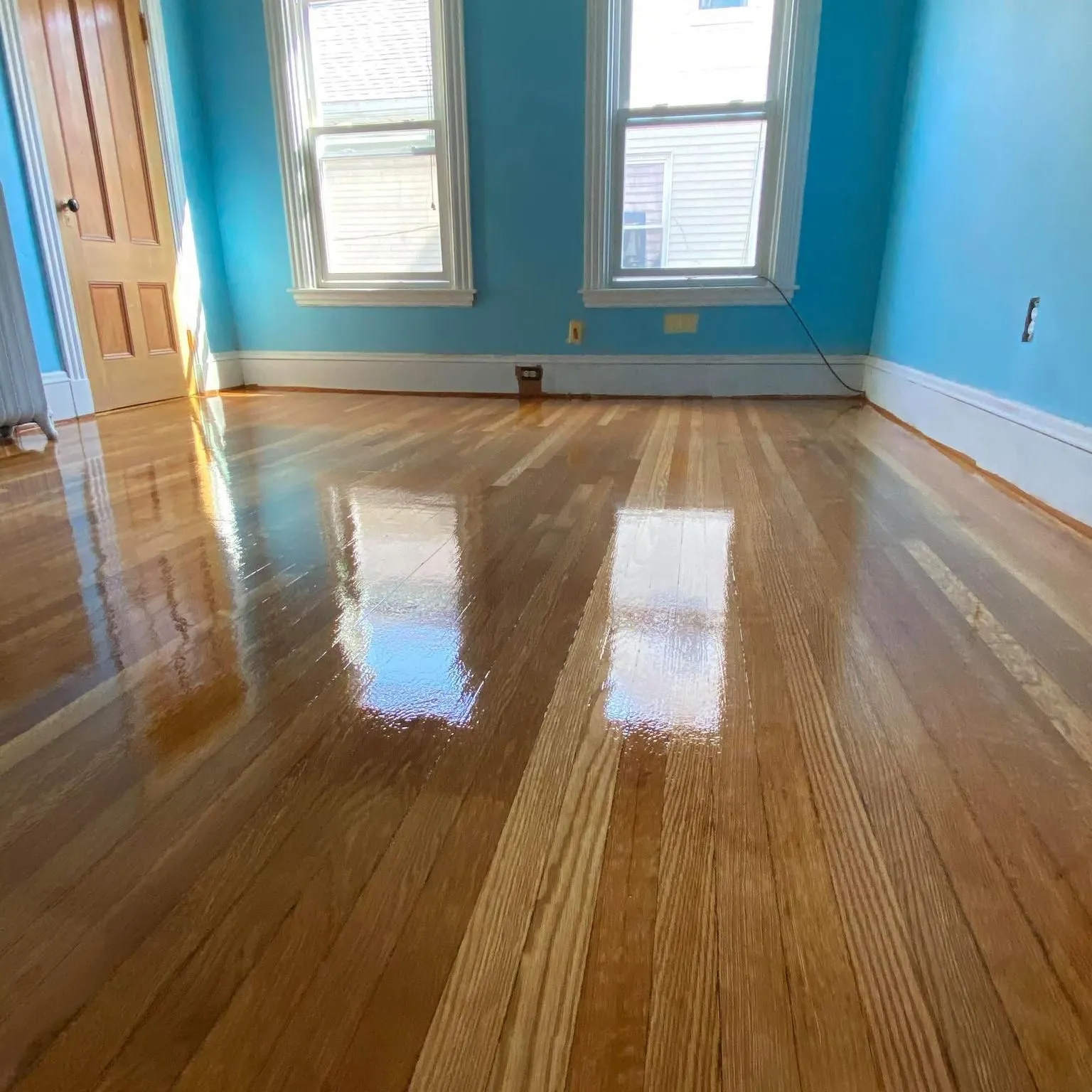 Refinished hardwood floor with high-gloss finish