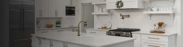 white tile backsplash in a kitchen with marble floors and white cabinets