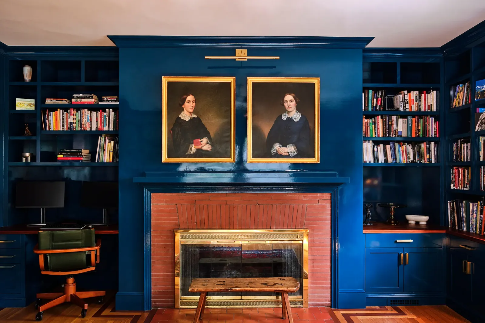 Blue built-in library and fireplace surround