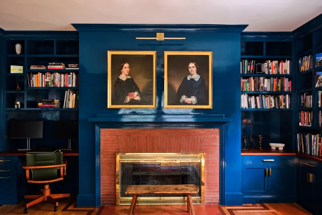 Blue built-in library and fireplace surround