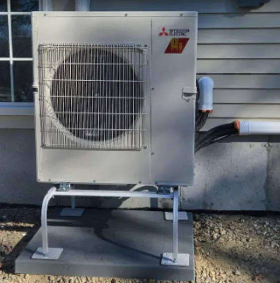 Mitsubishi outdoor heat pump installed on a raised equipment stand