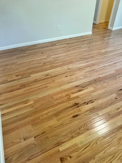 New hardwood flooring installed across a Merrimack living room