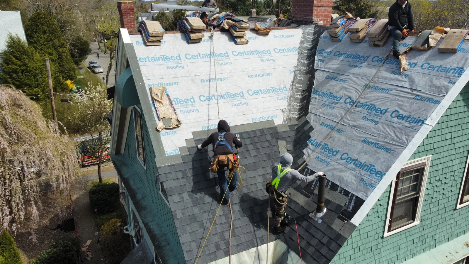 Aerial view of a completed architectural shingle roof installed by Storm King Roofing on a home in Duxbury, MA