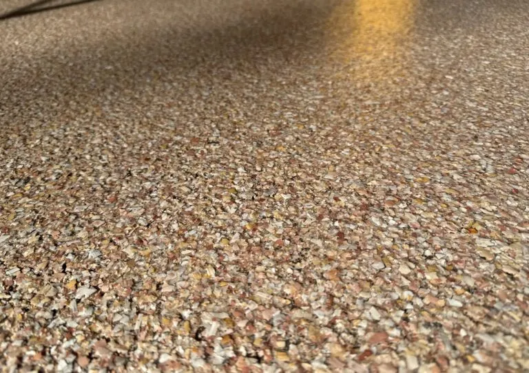 Up close shot of Talus chip variety sealed under new epoxy floor.