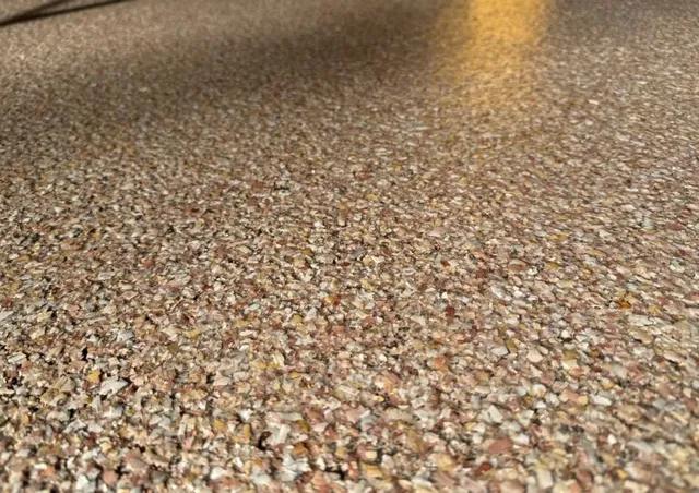 Up close shot of Talus chip variety sealed under new epoxy floor.