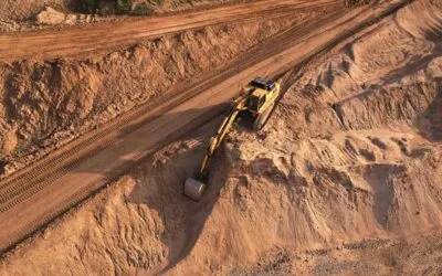 Excavator at grading and excavating site