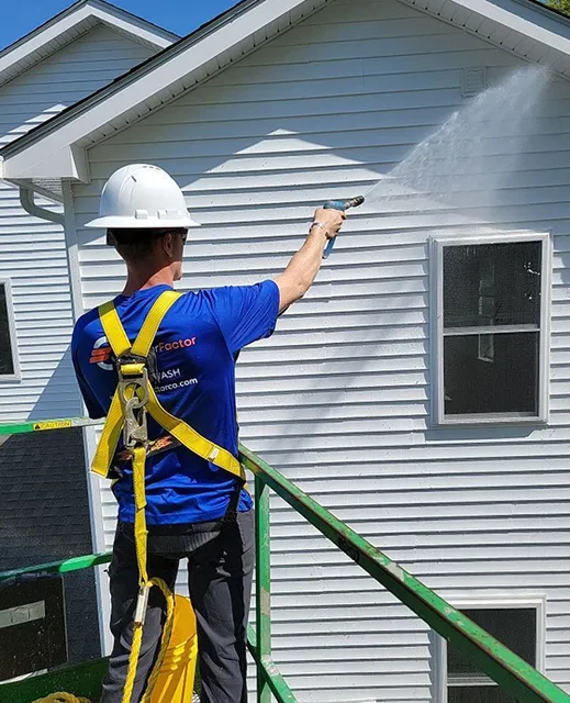 The Clear Factor professional washing siding on white home