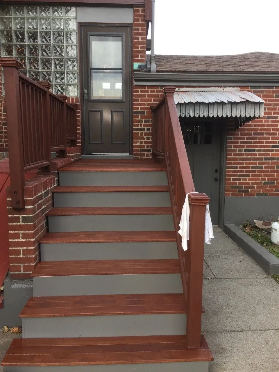 A set of wooden stairs leading up to a brick building