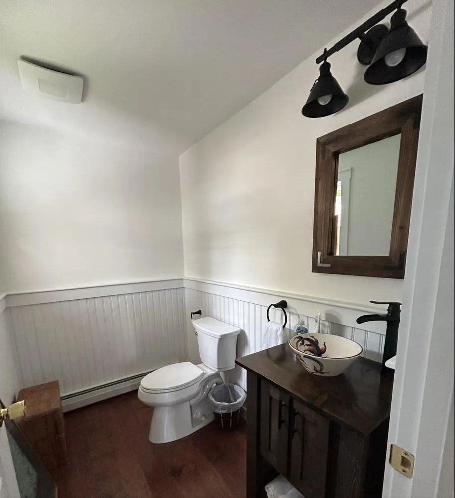 Powder room with new vanity light bar and exhaust fan