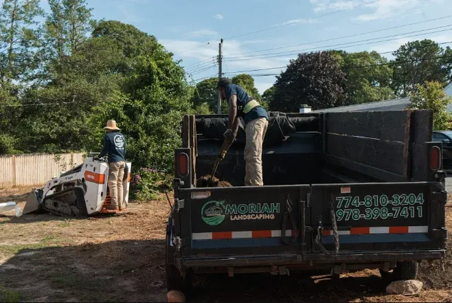 Moriah Masonry and Landscaping crew working with company dump truck in Cape Cod