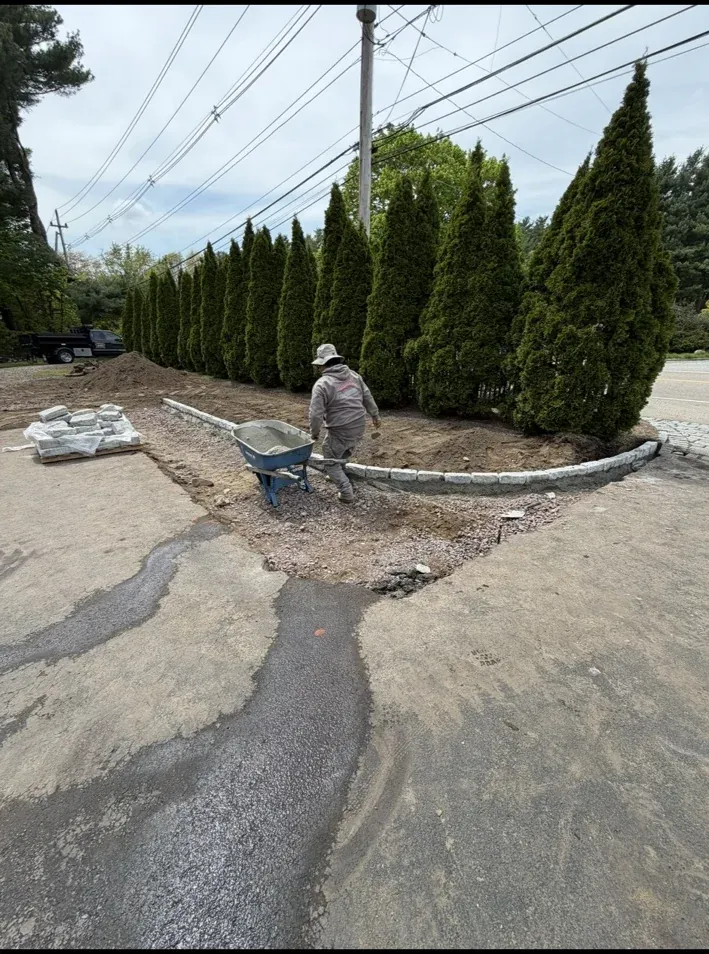 landscape bed installation with edging and plantings