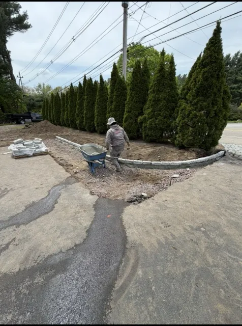 landscape bed installation with edging and plantings
