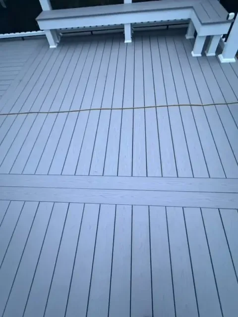 Close-up of gray composite deck boards and white posts