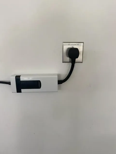 MJS Electrical Services - A power cord is plugged into a wall outlet.
