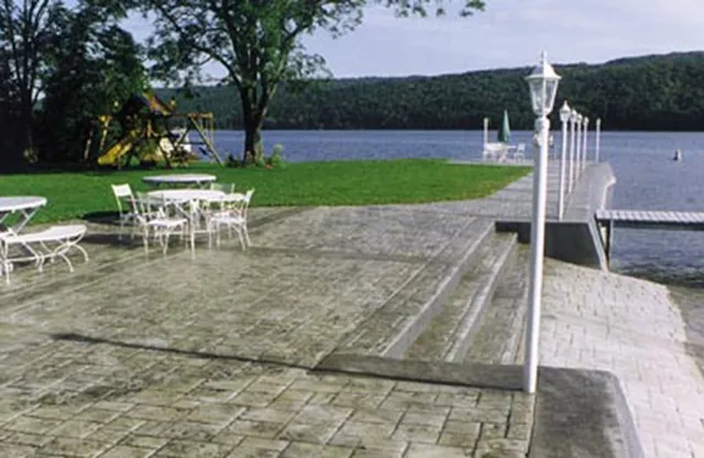 Lakeside stamped concrete patio with steps to dock