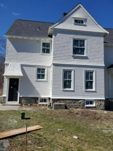 A large white house with a gray roof