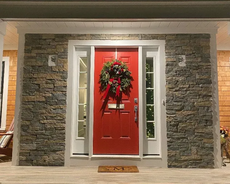 A red door with a christmas wreath on it
