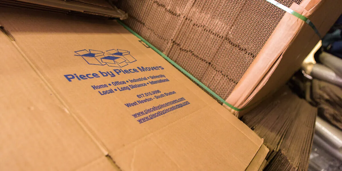 Company-branded moving boxes printed with 617.515.9886, West Newton / South Boston