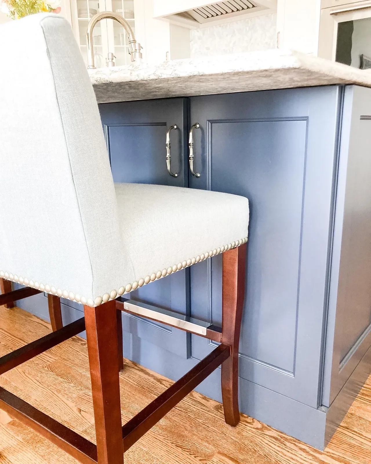 A transitional kitchen remodel in Worcester, MA with custom mosaic backsplash and blue island cabinetry