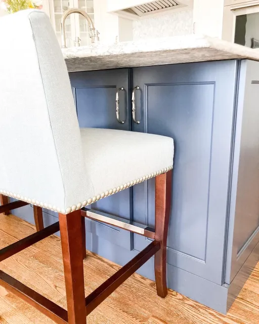 A transitional kitchen remodel in Worcester, MA with custom mosaic backsplash and blue island cabinetry