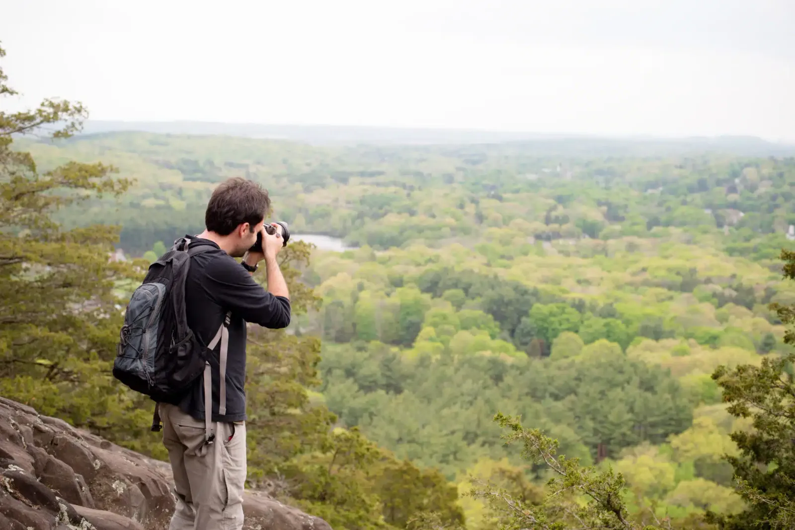 A man photographer hiking up a mountain