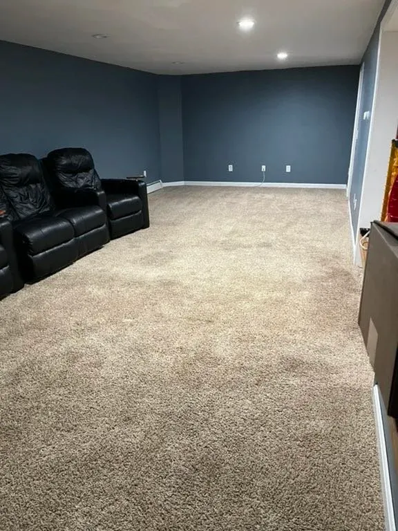 basement with carpet and blue walls