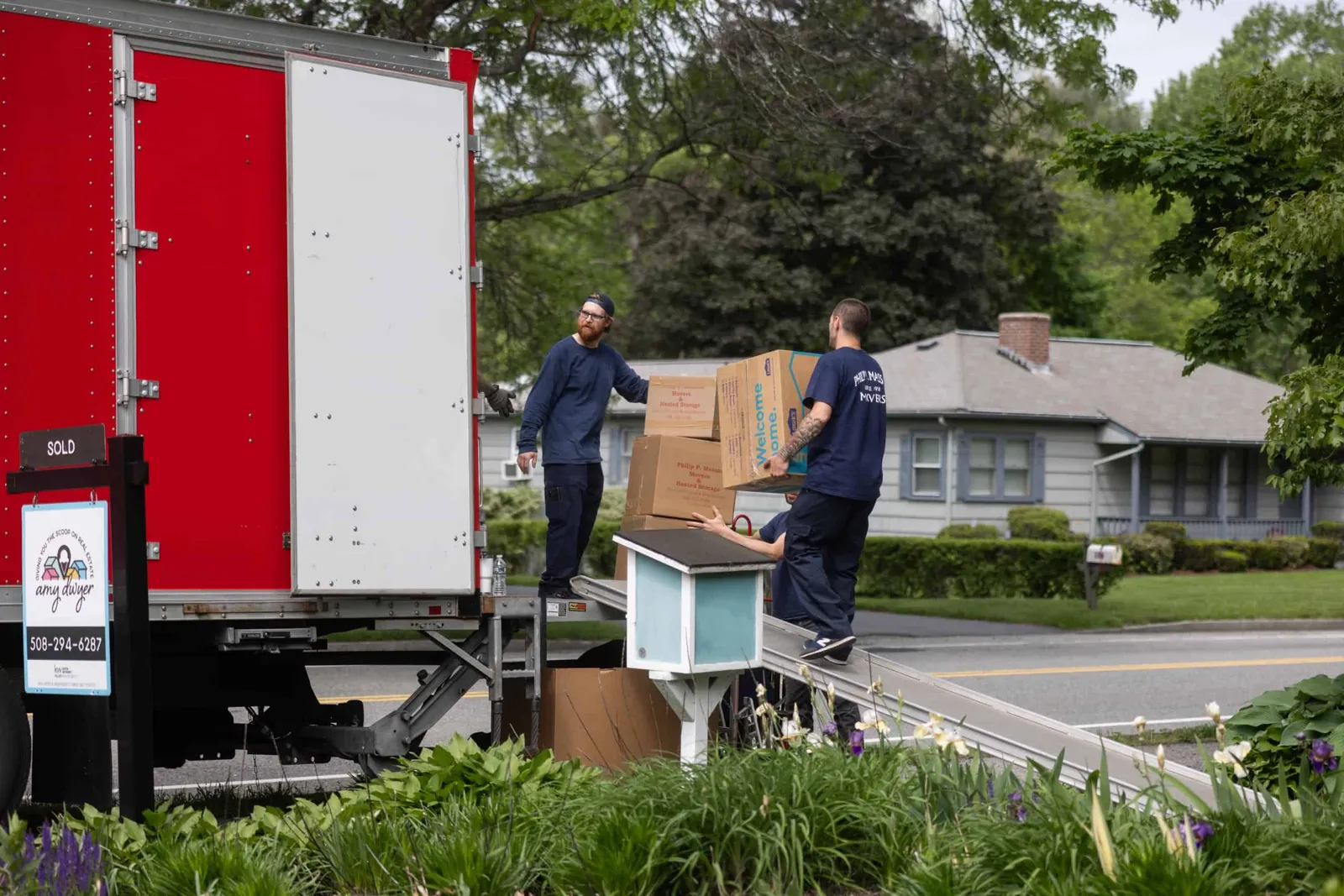 Two men unloading a moving truck.