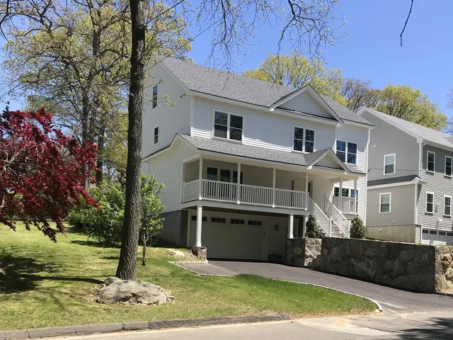 Covered porch and deck on a custom home by Ariola