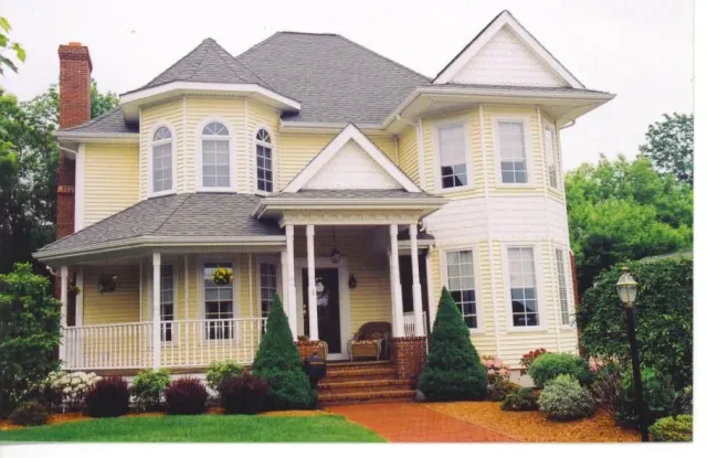 A large yellow house with a gray roof
