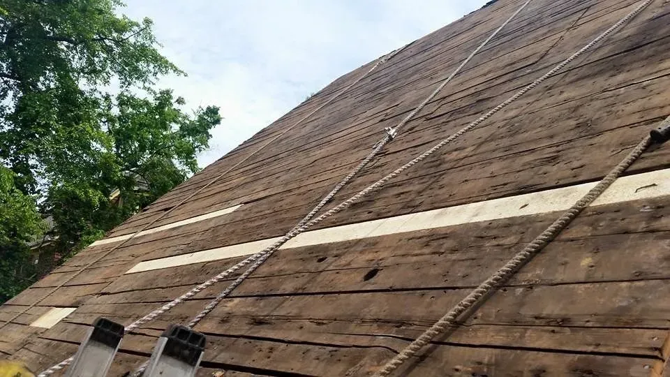 A wooden roof with a ladder attached to it