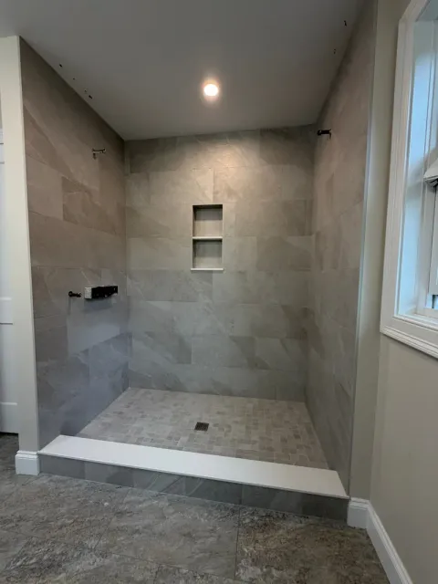 The finished stone-look shower seen from the bathroom