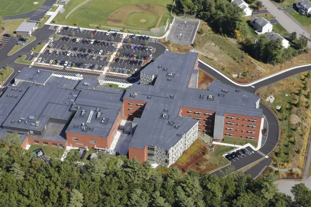 An aerial view of a large building surrounded by trees.