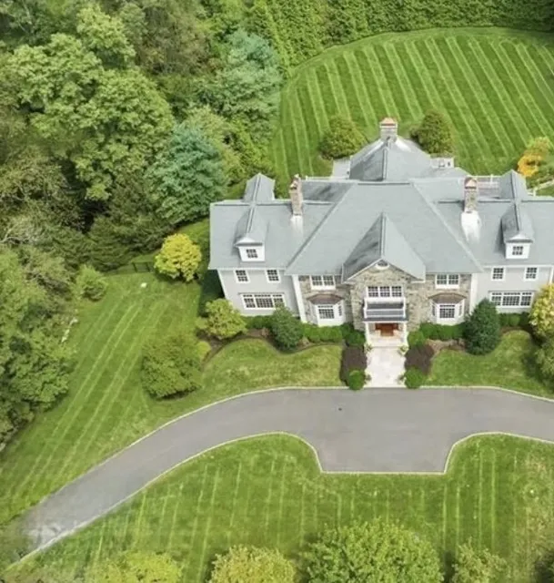 Aerial view of a stone home and its grounds