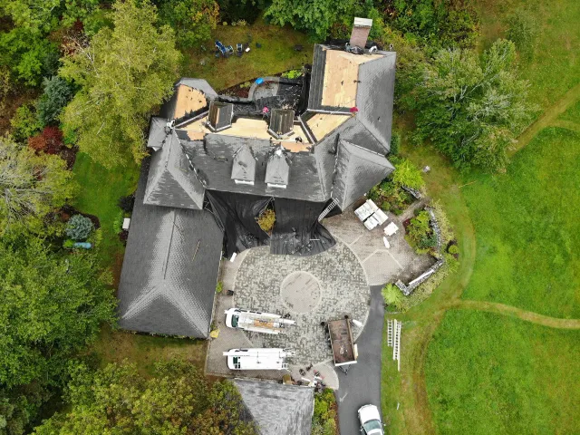 Large Home with Roof Half Stripped Off During Roof Replacement Project