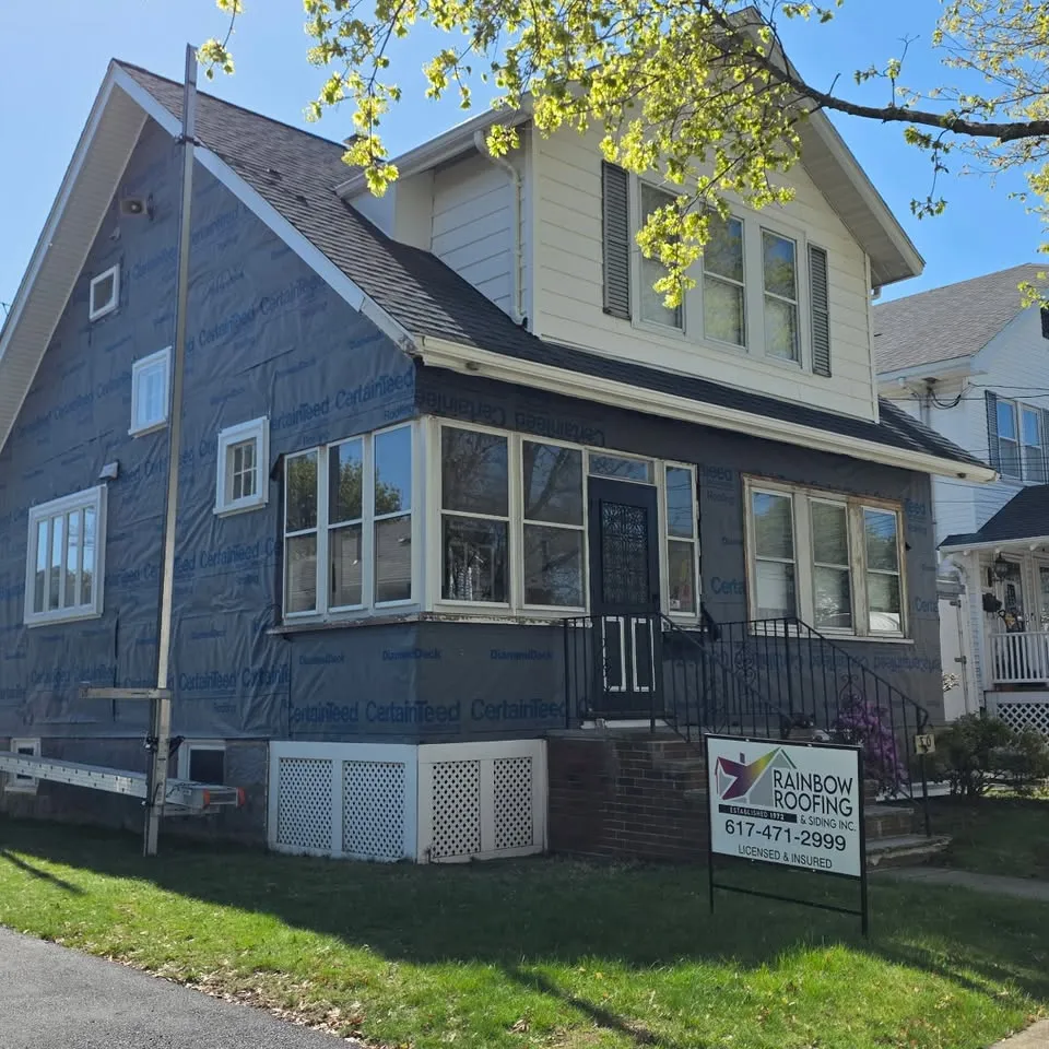 Completed blue vinyl siding on a two-family home