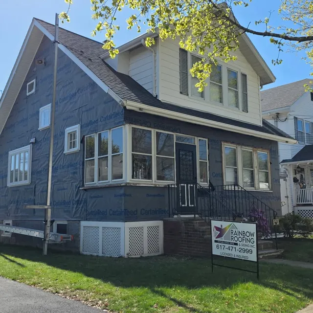 Completed blue vinyl siding on a two-family home