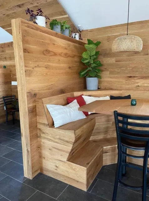 Custom high bench with high top table, wrap around for local restaurant. Wall sheathing in white oak with custom ceiling woodworking sheathing. custom design branford CT guilford and madison new haven