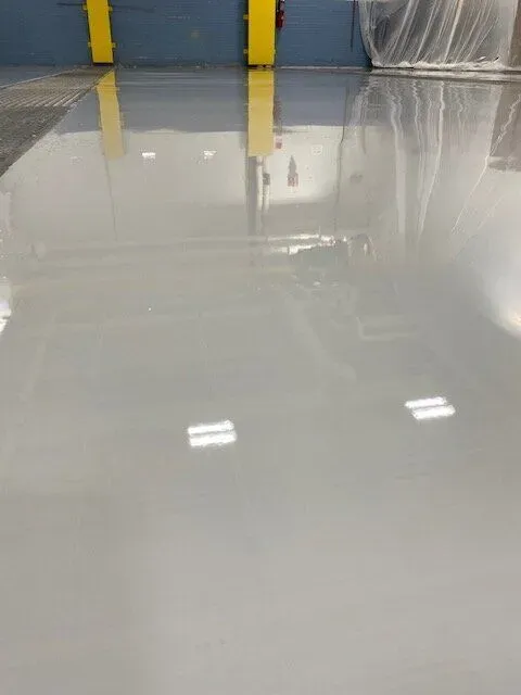 A close up of a white concrete floor in a building.