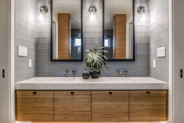 A bathroom with two sinks and two mirrors.