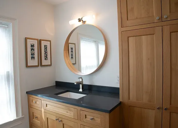 Custom bathroom vanity with tailored storage, hardware, and countertop details.