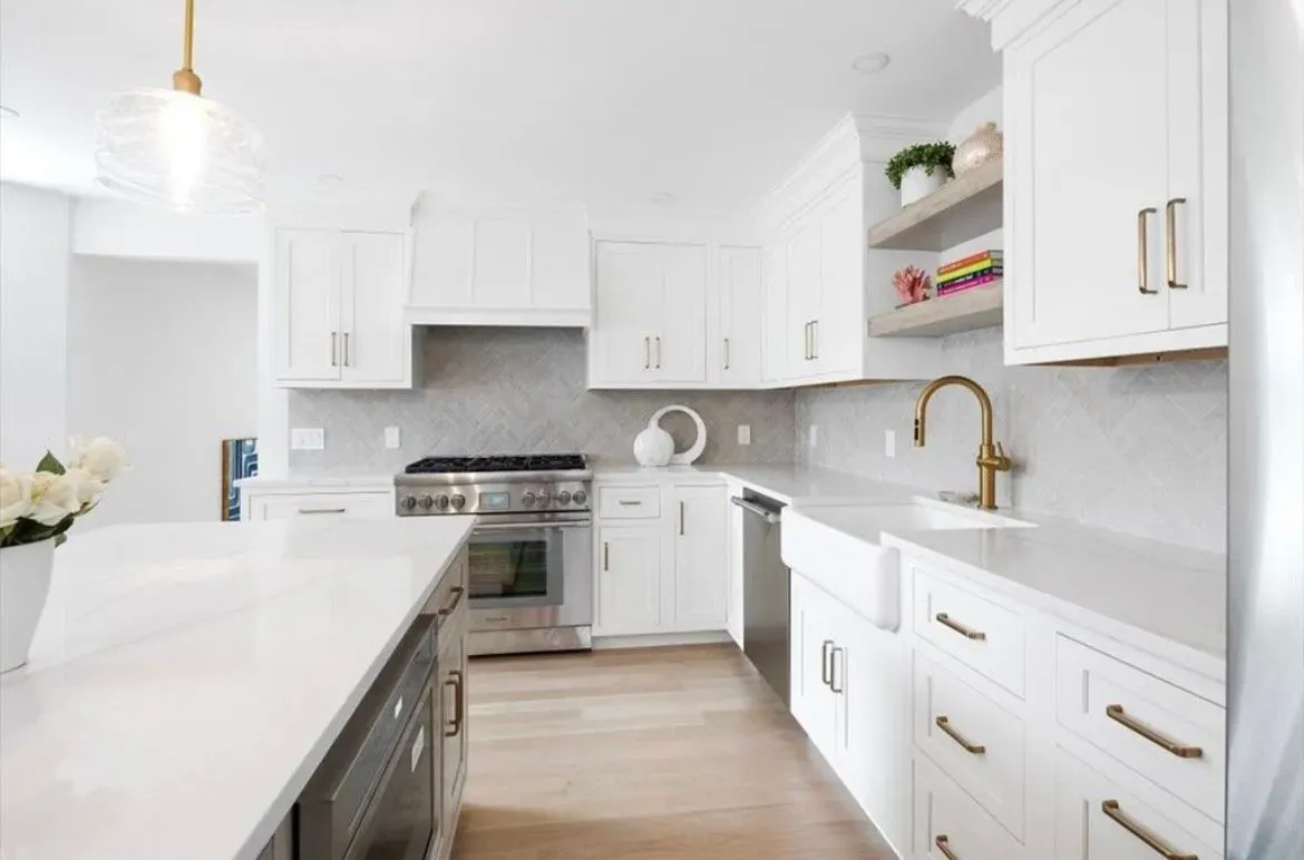 A kitchen with white cabinets and stainless steel appliances.