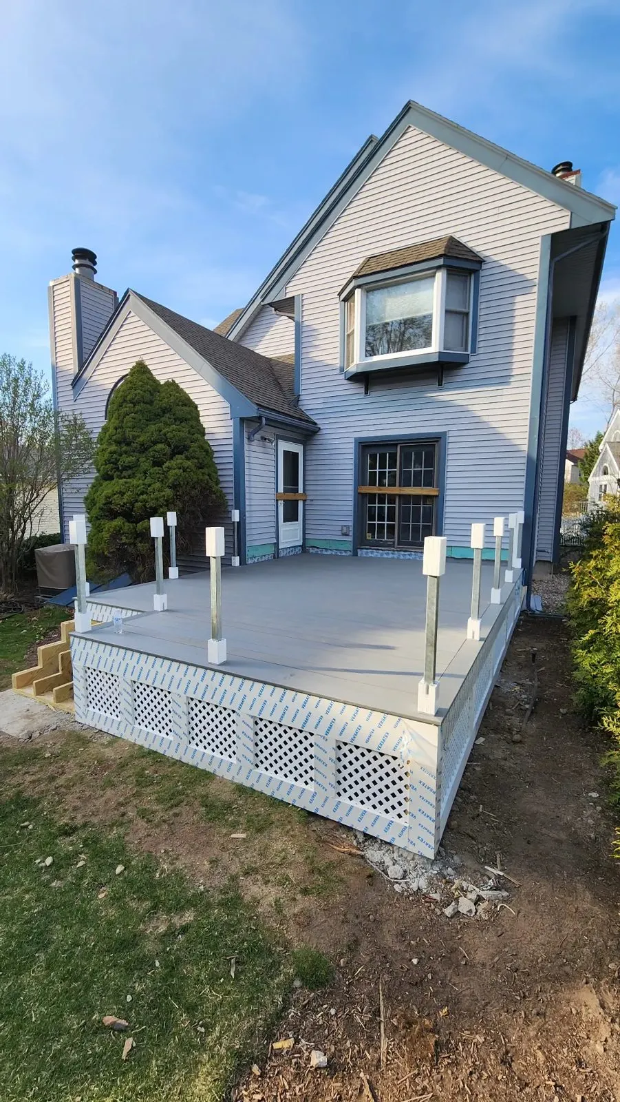 Finished composite deck with railing posts and lattice skirting