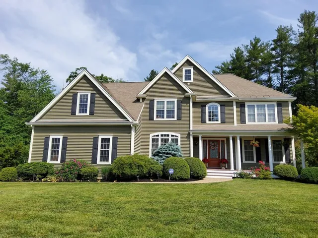 Beautiful american house with a lawn and trees in the back yard